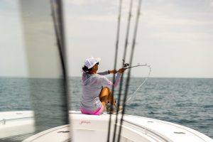 Connie Arias casting from bow of 36 Offshore